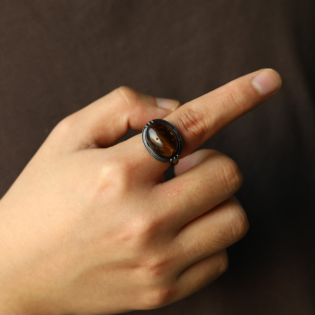 Olivenorma Anello regolabile nero ovale con occhio di tigre